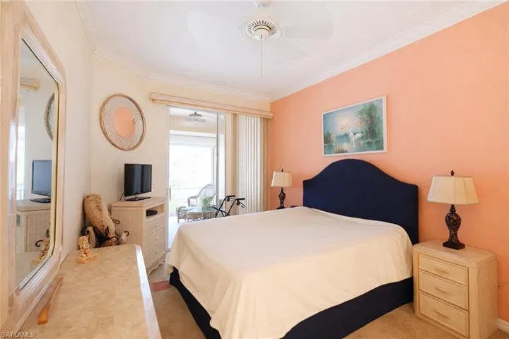 Bedroom featuring ceiling fan and ornamental molding