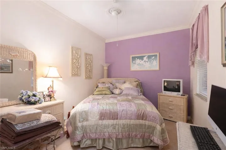 Carpeted bedroom featuring ornamental molding
