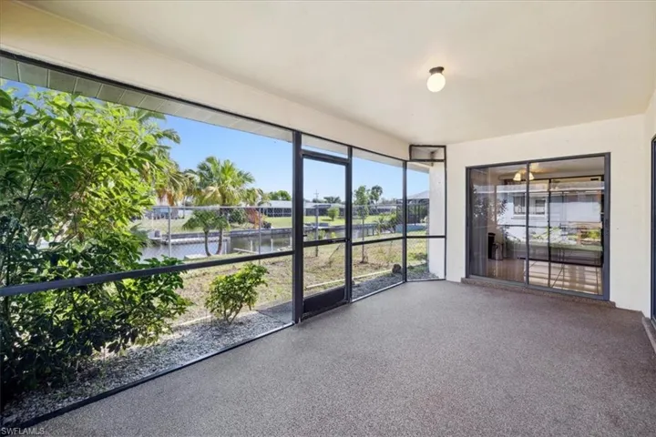 Unfurnished sunroom with a water view