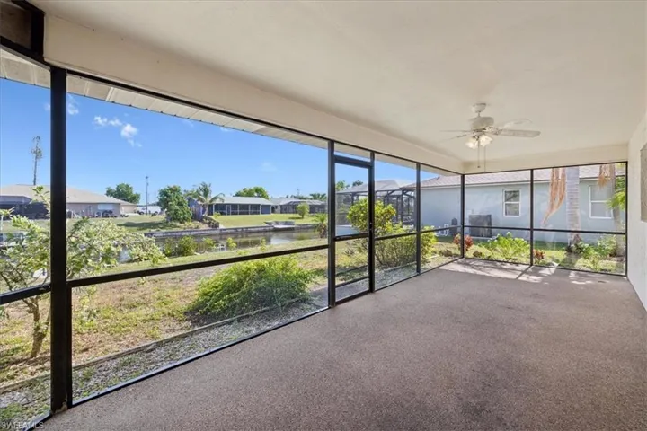 Unfurnished lanai featuring a ceiling fan, and a gulf access waterfront view.