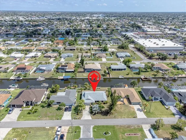 Aerial overview of property's location featuring a large body of water and nearby suburban area