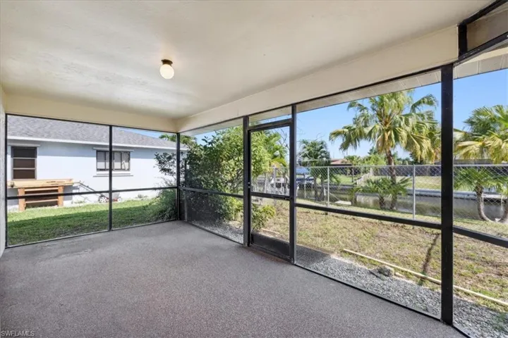 Unfurnished sunroom featuring a water view