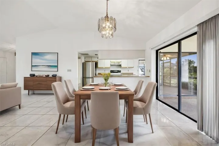 Dining area with lofted ceiling and a chandelier