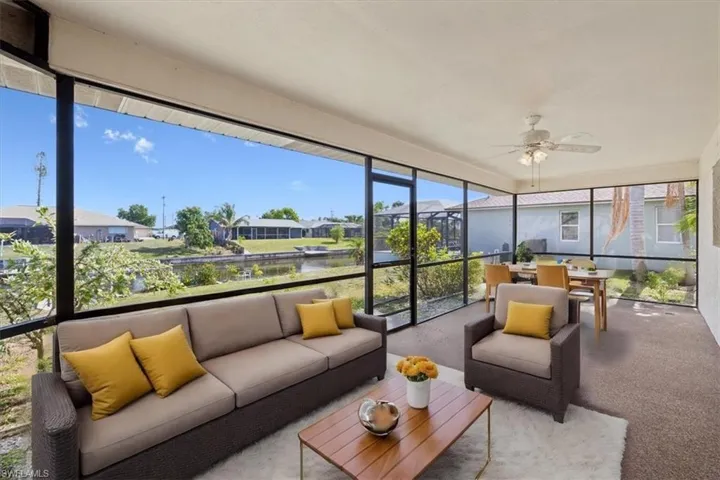 Sunroom with an outdoor living space, ceiling fan, outdoor dining area, and a residential view