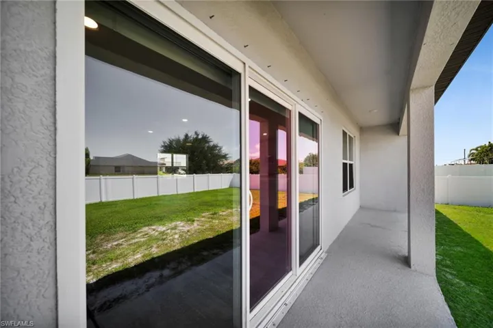 Covered patio featuring a textured concrete slab and stucco exterior finish