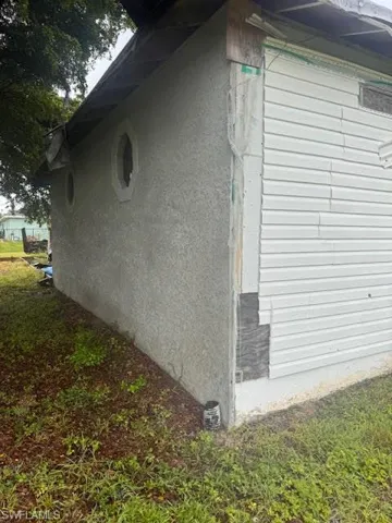 View of side of property featuring stucco siding