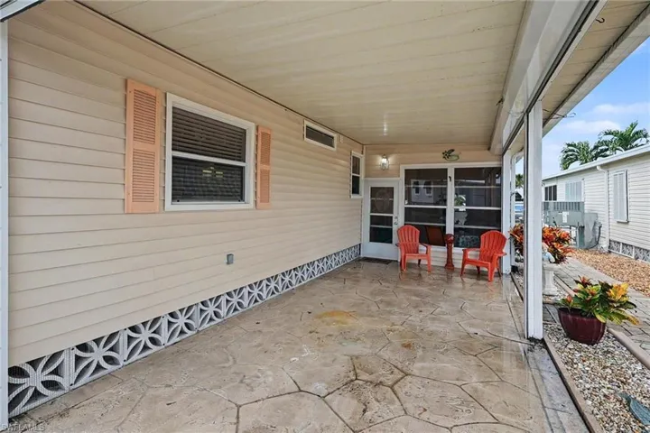 Covered patio with stamped concrete flooring, screened enclosure, and decorative lattice skirting