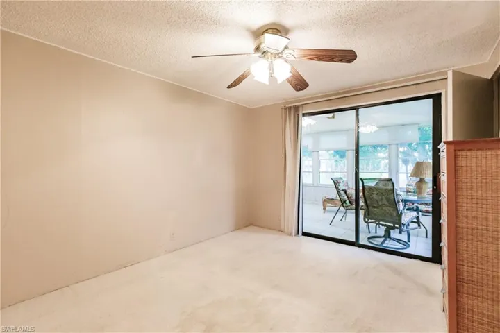 Unfurnished room with carpet flooring, a textured ceiling, and ceiling fan