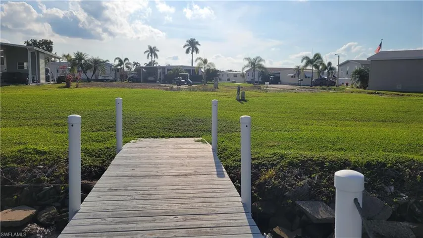 Dock area looking back to lot featuring the lawn