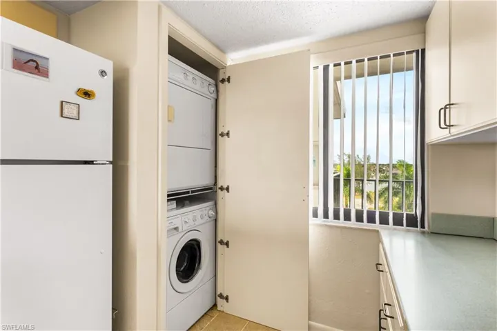 Laundry closet located in corner of the kitchen. Extra counter for folding clothes.