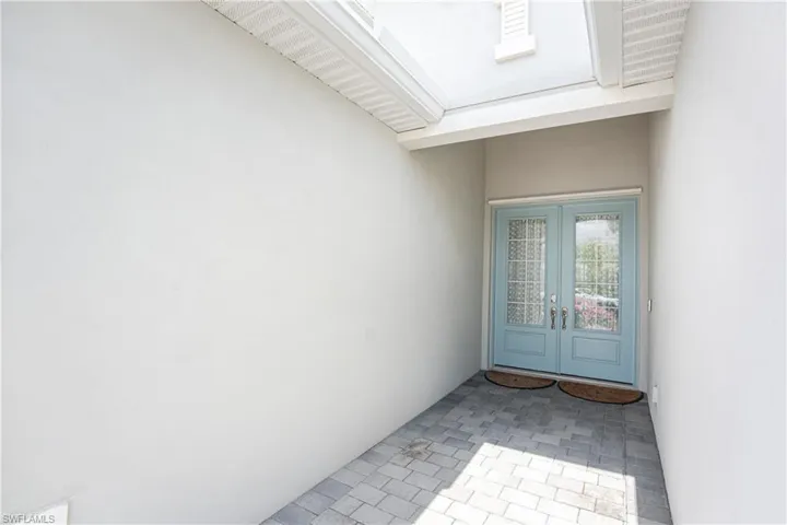 Entrance to property with stucco siding and french doors