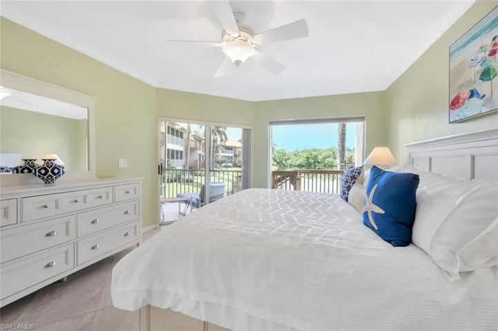 Bedroom featuring crown molding, access to exterior, a ceiling fan, and light tile patterned flooring