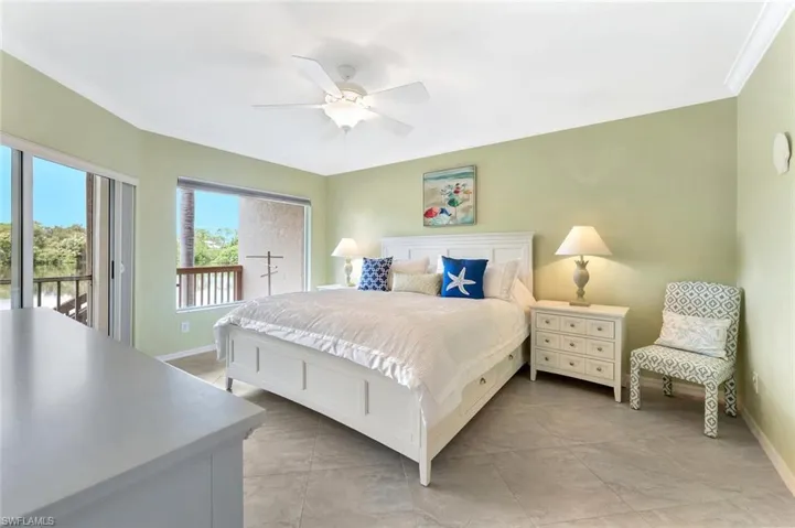 Bedroom with crown molding, access to exterior, a ceiling fan, and light tile patterned floors