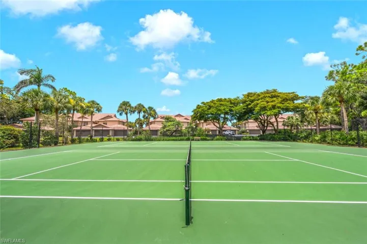 View of tennis court featuring community basketball court and a residential view