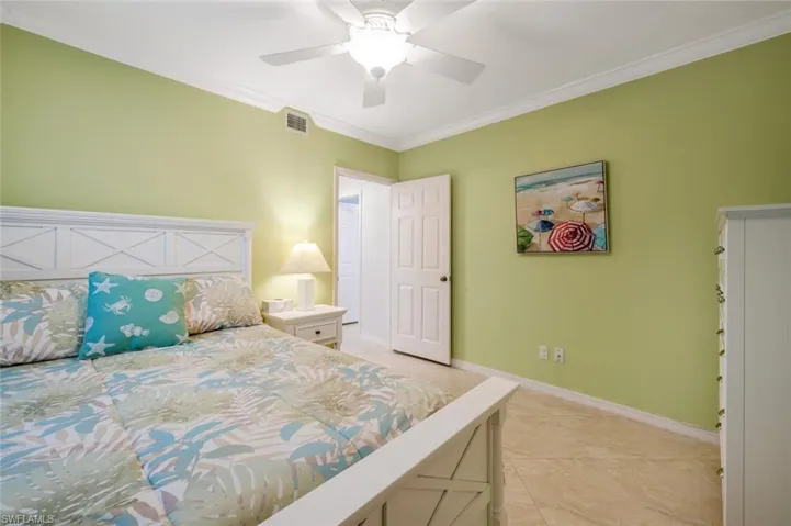 Bedroom featuring ornamental molding and a ceiling fan