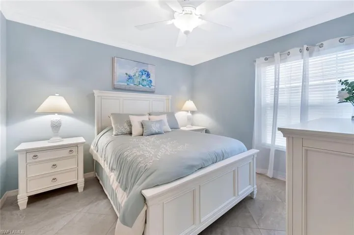 Bedroom featuring ceiling fan and crown molding
