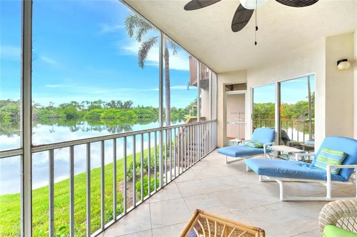 Lanai a water view, a textured wall, and a textured ceiling