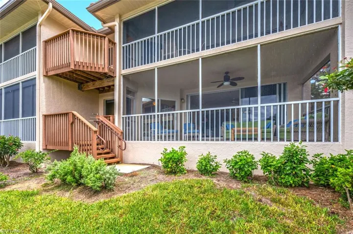 Back of property featuring stairway, a patio, a ceiling fan, a sunroom, and stucco siding