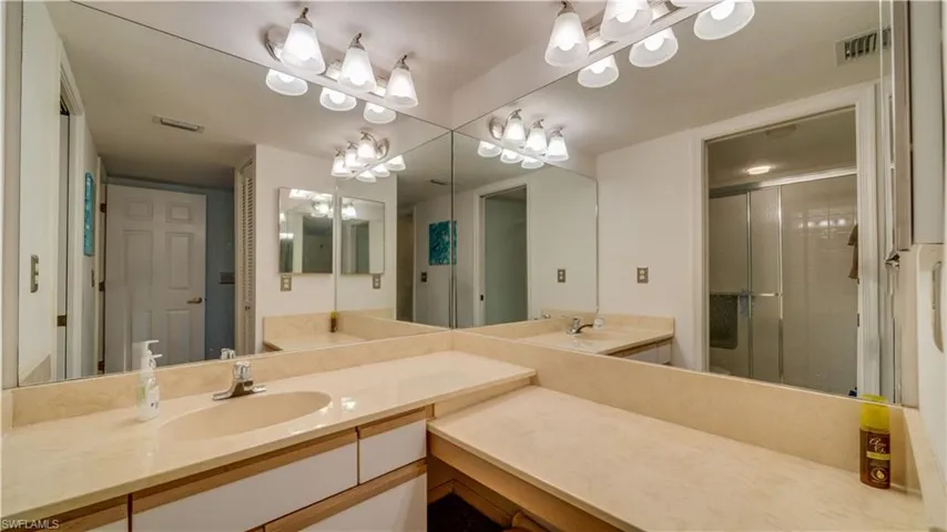 Bathroom with vanity and a shower with shower door
