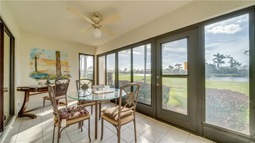 Sunroom / solarium with a water view and ceiling fan
