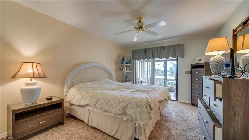 Carpeted bedroom featuring access to exterior and ceiling fan