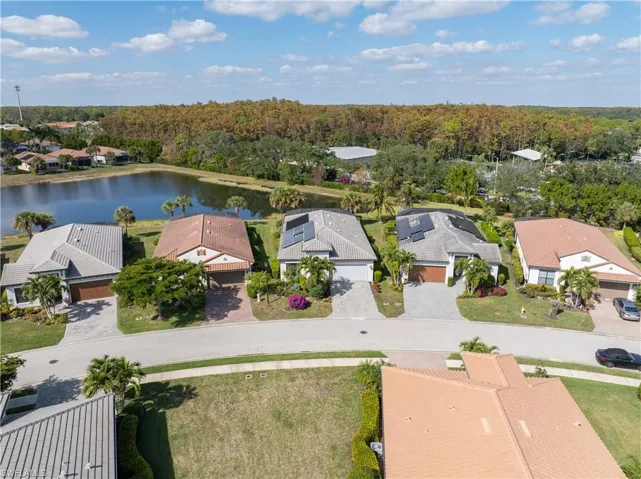 Aerial view of residential area featuring a nearby body of water