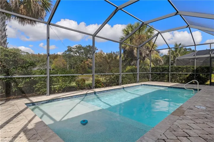 Outdoor pool featuring a lanai, a sunroom, and a patio