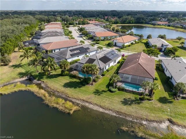 Aerial view of residential area featuring a nearby body of water