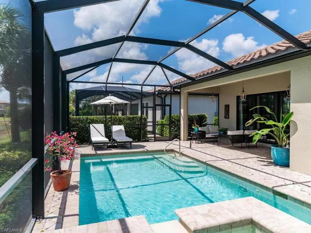 View of swimming pool with a patio area, an outdoor living space, and a lanai
