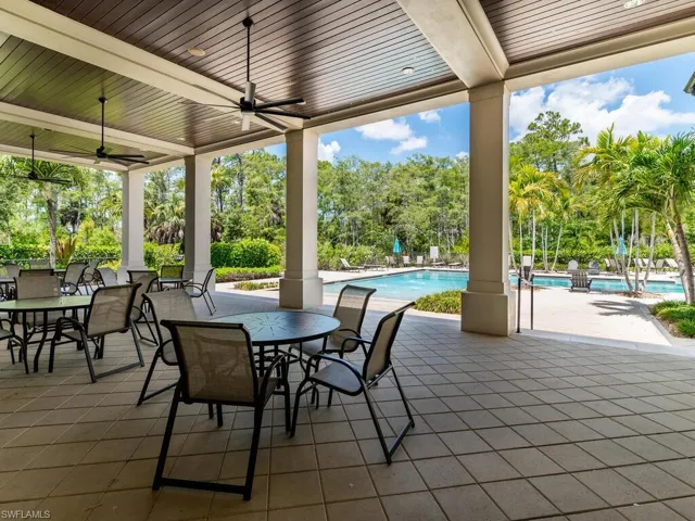 View of patio featuring a community pool and ceiling fan