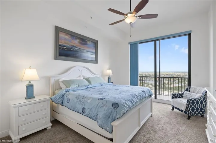 Bedroom with carpet flooring, access to outside, and a ceiling fan