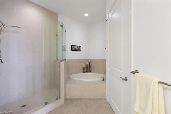 Full bath featuring a stall shower, a garden tub, tile patterned floors, and recessed lighting
