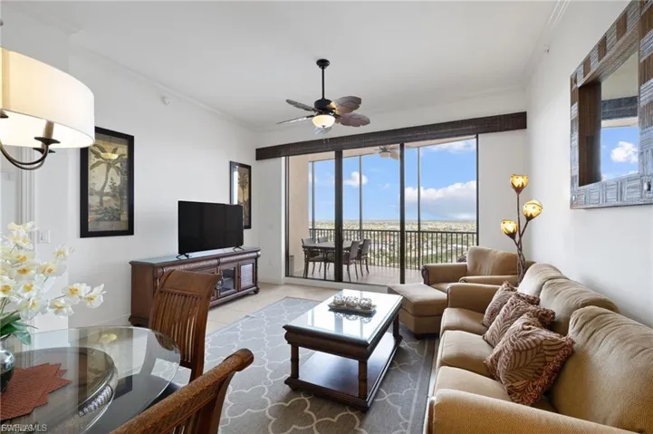 Living room with crown molding and ceiling fan