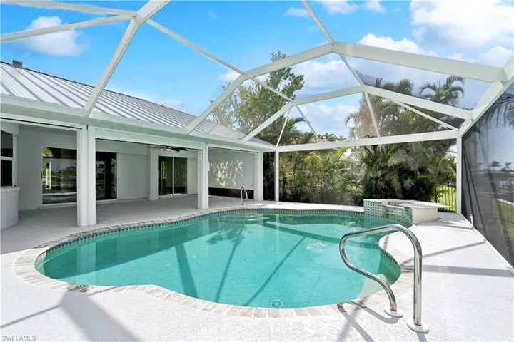View of pool featuring a lanai, ceiling fan, and a patio area