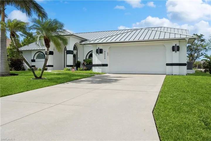 Entrance to property with a lawn and french doors
