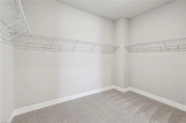 Walk in closet featuring carpet flooring