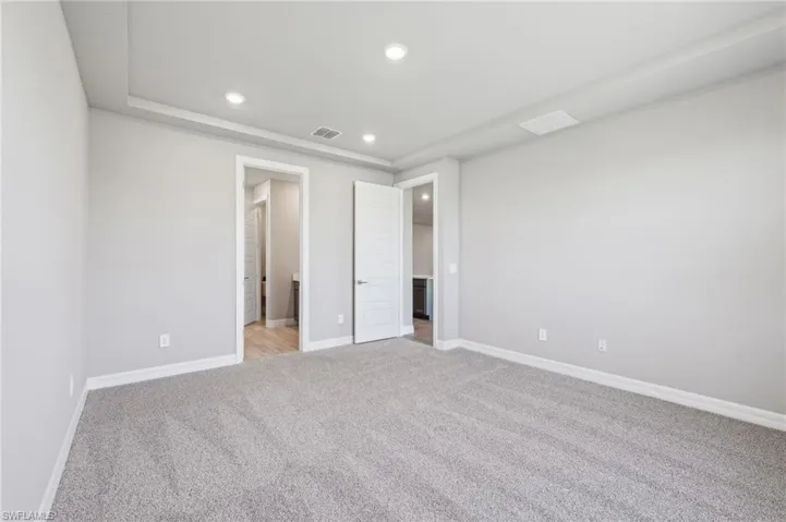 Unfurnished bedroom featuring light colored carpet, recessed lighting, and baseboards