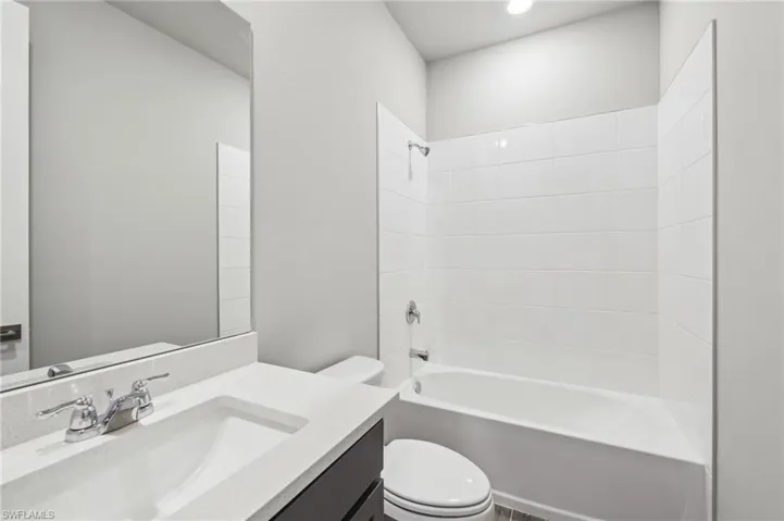 Full bath featuring toilet, bathtub / shower combination, and vanity