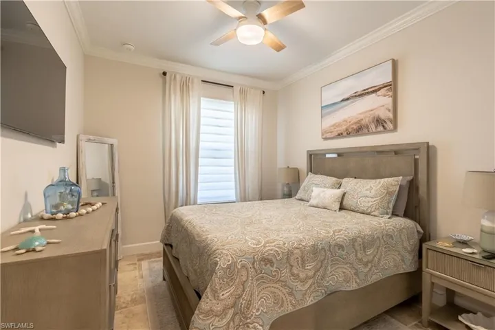 Bedroom with crown molding and a ceiling fan