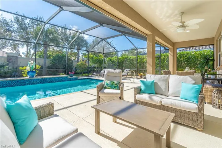 Outdoor pool with outdoor lounge area, a patio area, glass enclosure, and a sunroom