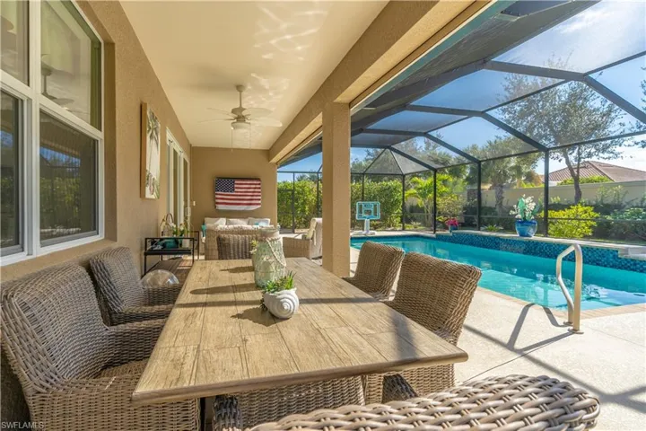Outdoor pool with a patio, a sunroom, a lanai, an outdoor hangout area, and outdoor dining area