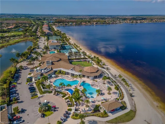 Bird's eye view of a pool area and a nearby body of water