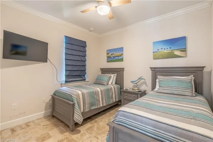 Bedroom featuring ornamental molding and ceiling fan