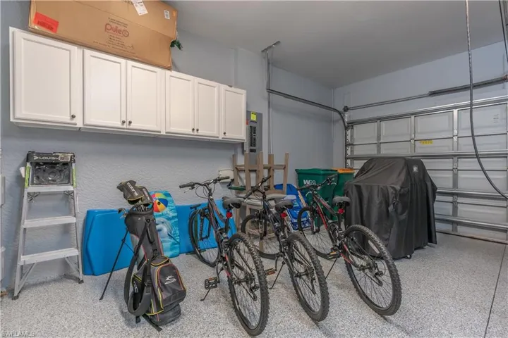 Garage with electric panel and a textured wall