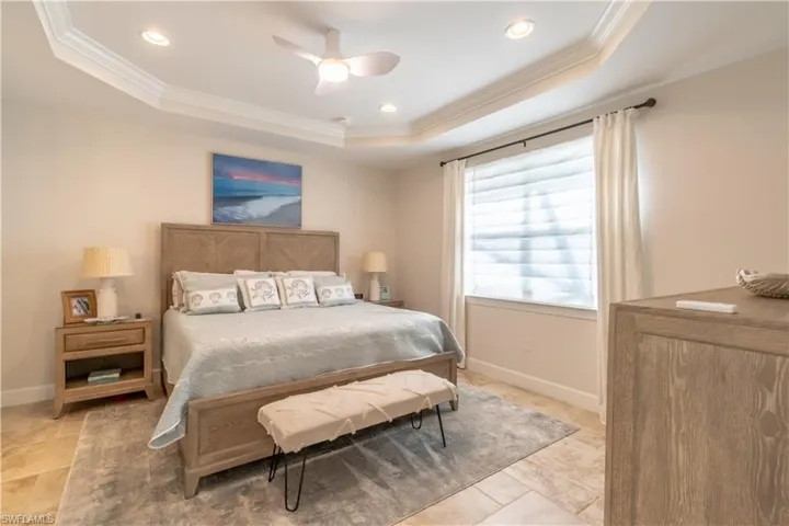 Bedroom featuring crown molding, a ceiling fan, recessed lighting, and a raised ceiling