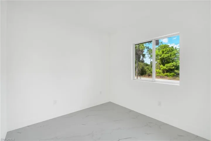 Spare room with baseboards and light marble finish flooring