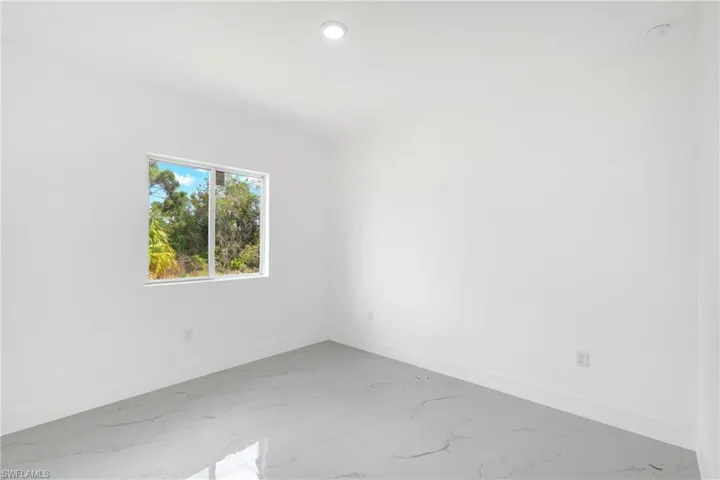 Spare room featuring light marble finish floors and recessed lighting