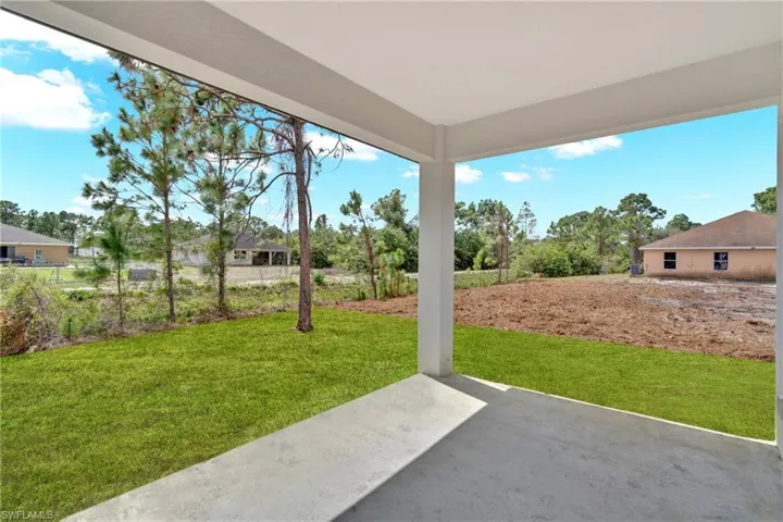 View of green lawn featuring a patio area