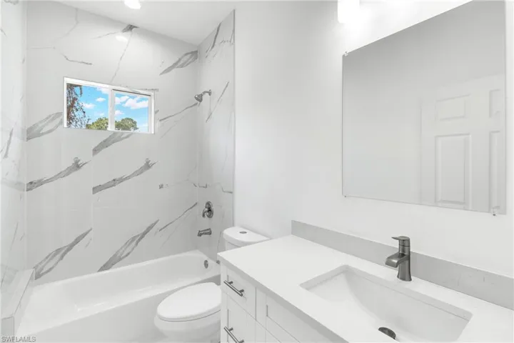 Bathroom with vanity and shower / washtub combination