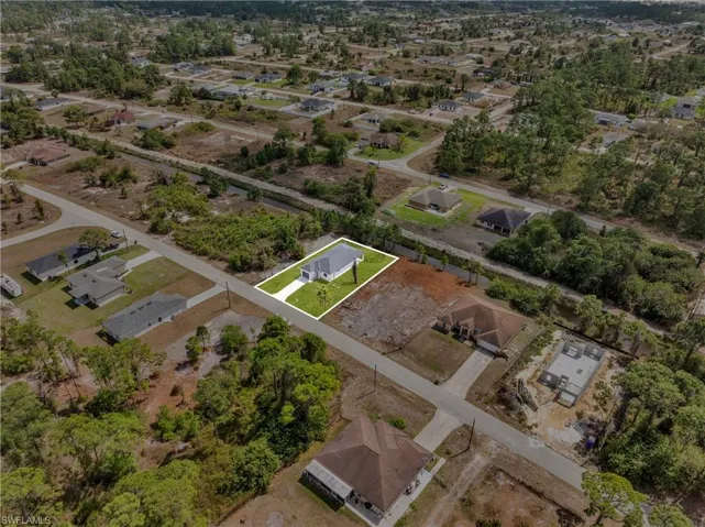 Aerial perspective of suburban area featuring property boundaries highlighted